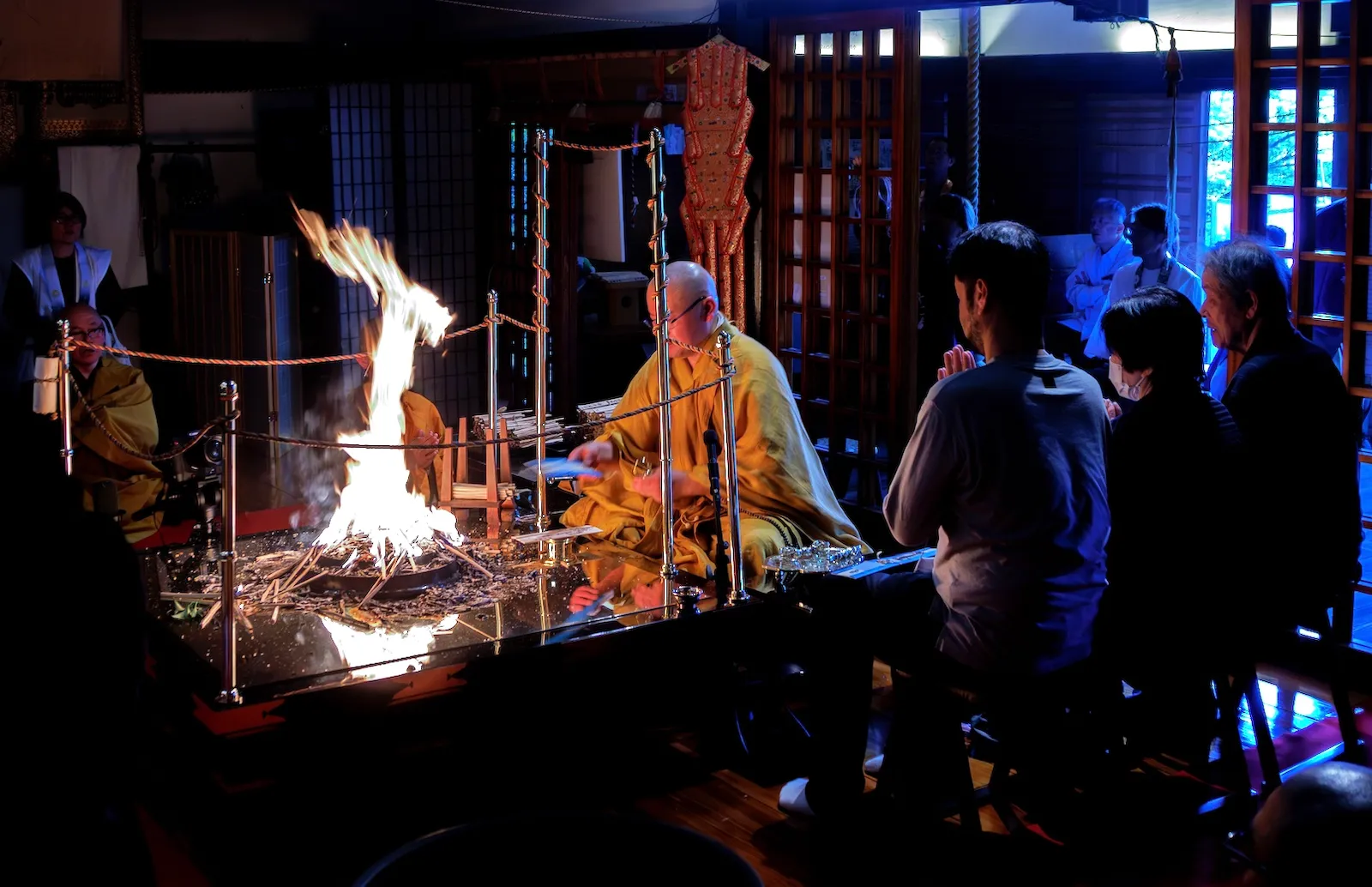 平等寺本堂內，參拜者圍繞護摩壇合掌